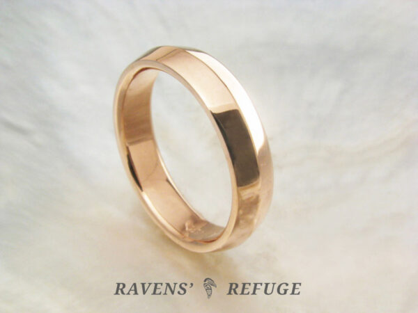 5mm knife edge wedding band hand forged in 14k rose gold with comfort fit profile and polished finish.