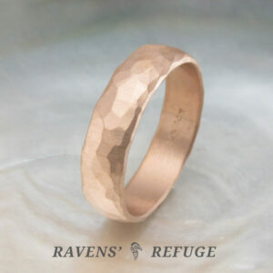 6mm hammered men's wedding band in rose gold with a domed profile and matte finish