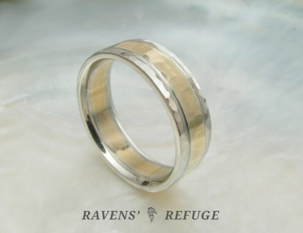 6mm wedding band with yellow gold center and white gold edges. Flat profile, hammered effect.