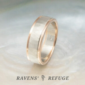 hammered white gold wedding band with rose gold rails