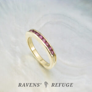 channel set rhodolite garnets in 18k yellow gold, an elegant handmade anniversary ring