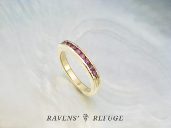 channel set rhodolite garnets in 18k yellow gold, an elegant handmade anniversary ring